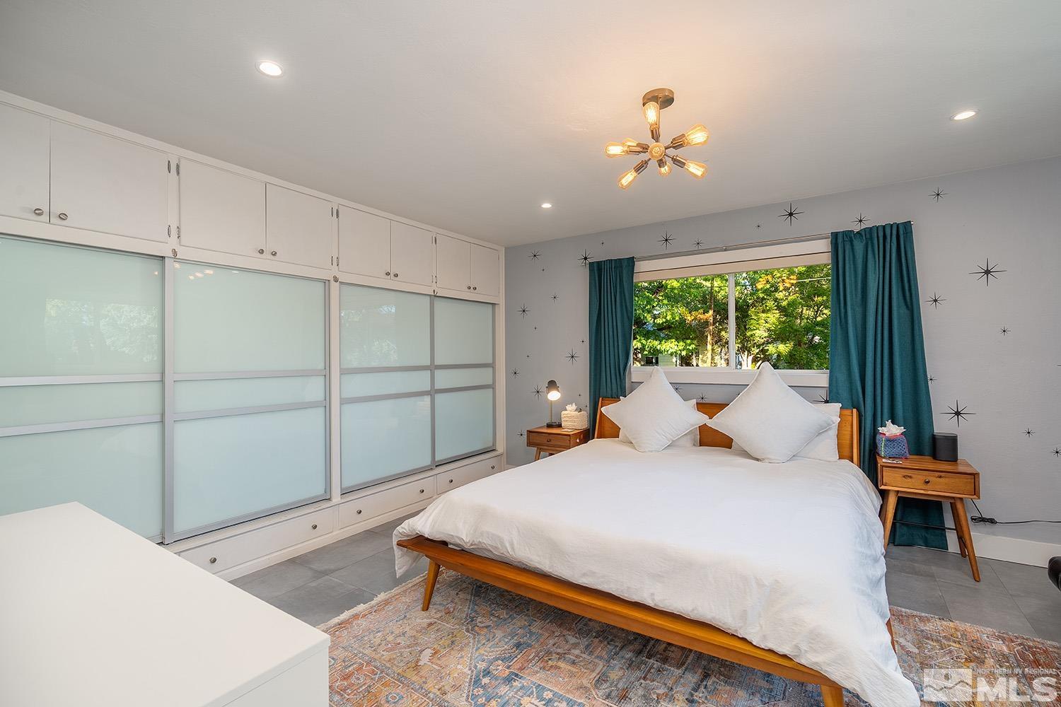 401 Brown Street Reno, NV 89509 - Photo 22 of 40 a bed room with a bed and a chandelier