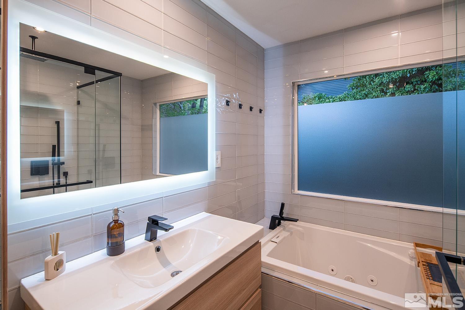 401 Brown Street Reno, NV 89509 - Photo 25 of 40 a bathroom with a tub sink and mirror