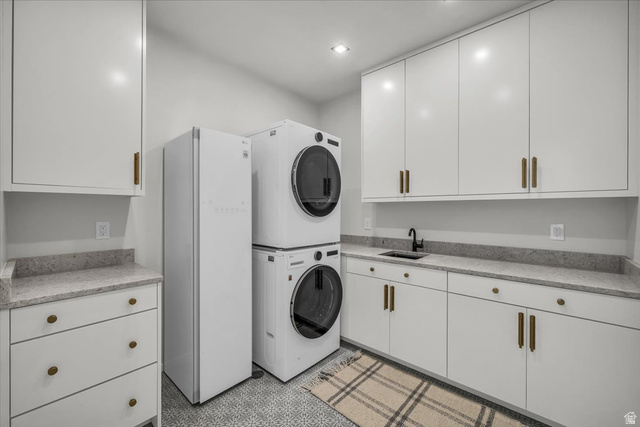 2152 South 30 West Orem, UT 84058 - Photo 41 of 56 Laundry area with stacked washer / dryer, light flooring, and cabinet space