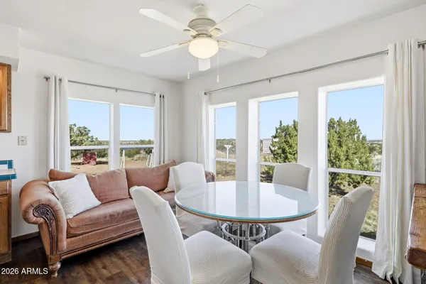 a dining room with furniture a large window and a chandelier