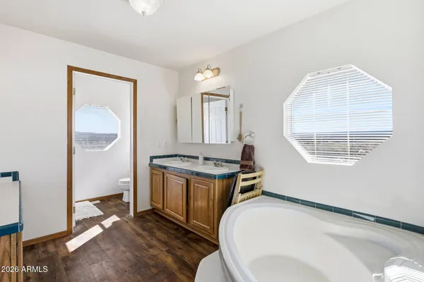 a large white kitchen with sink stove and refrigerator
