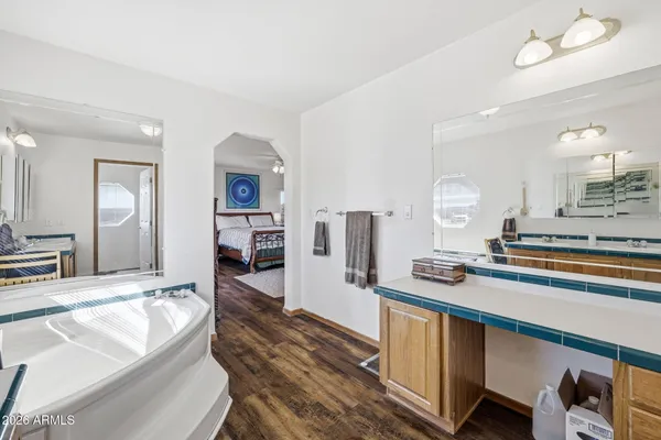 a bathroom with a glass shower door and a sink
