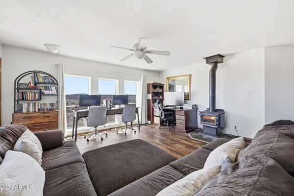 a living room with furniture a chandelier and a fireplace