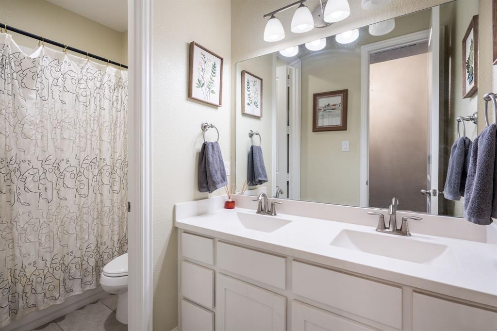 1501 Snowdrop Drive Prosper, TX 75078 - Photo 24 of 27 a bathroom with a double vanity sink mirror and toilet