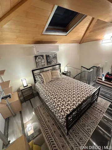 a bed sitting in a bedroom next to a window