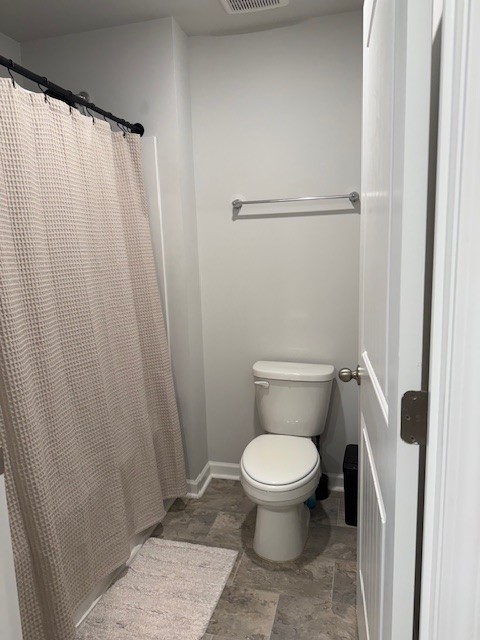 7301 Golden Way White House, TN 37188 - Photo 27 of 30 a white toilet sitting next to a shower curtain