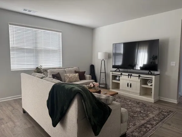 a kitchen with stainless steel appliances granite countertop a sink a stove a refrigerator and chairs
