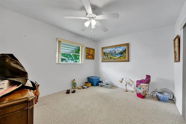 a bedroom with bed and a chandelier