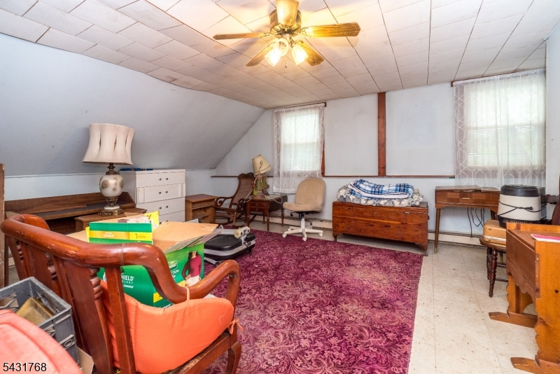 400 Mechlin Corner Road Pittstown, NJ 08867 - Photo 19 of 29 a living room with lots of furniture and a dining table