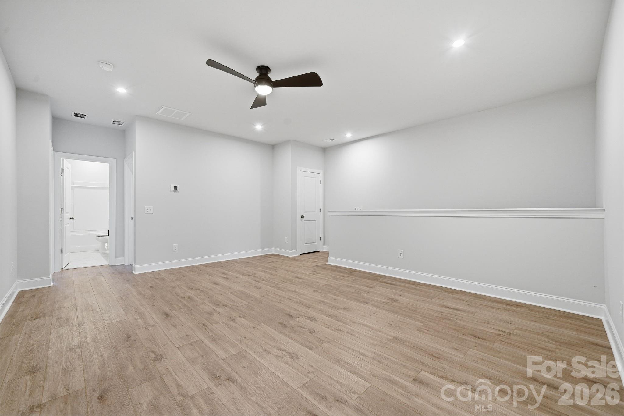 1823 Viewfield Road Fort Mill, SC 29708 - Photo 19 of 43 an empty room with wooden floor and windows