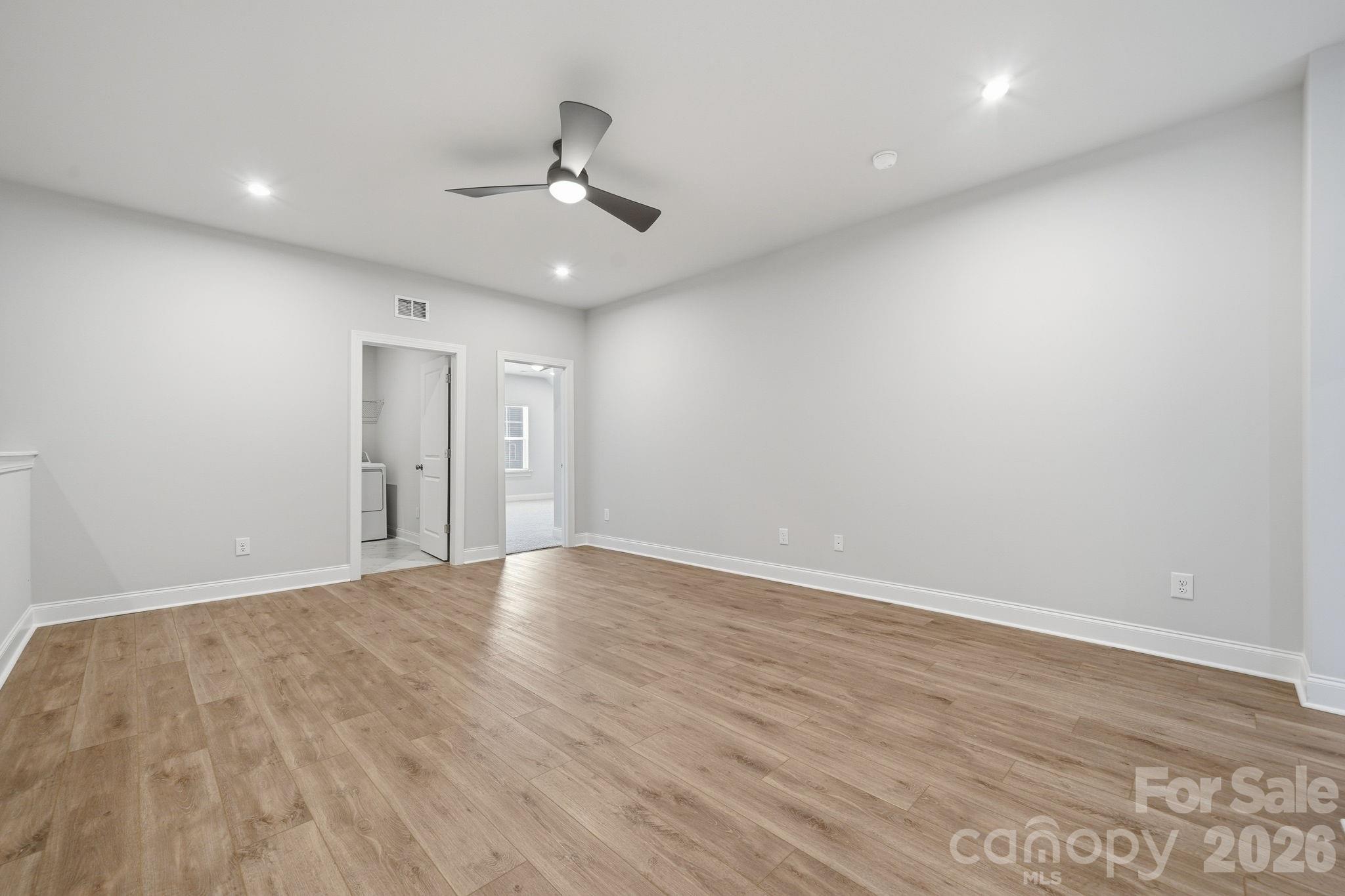 1823 Viewfield Road Fort Mill, SC 29708 - Photo 20 of 43 a view of an empty room with wooden floor and a ceiling fan