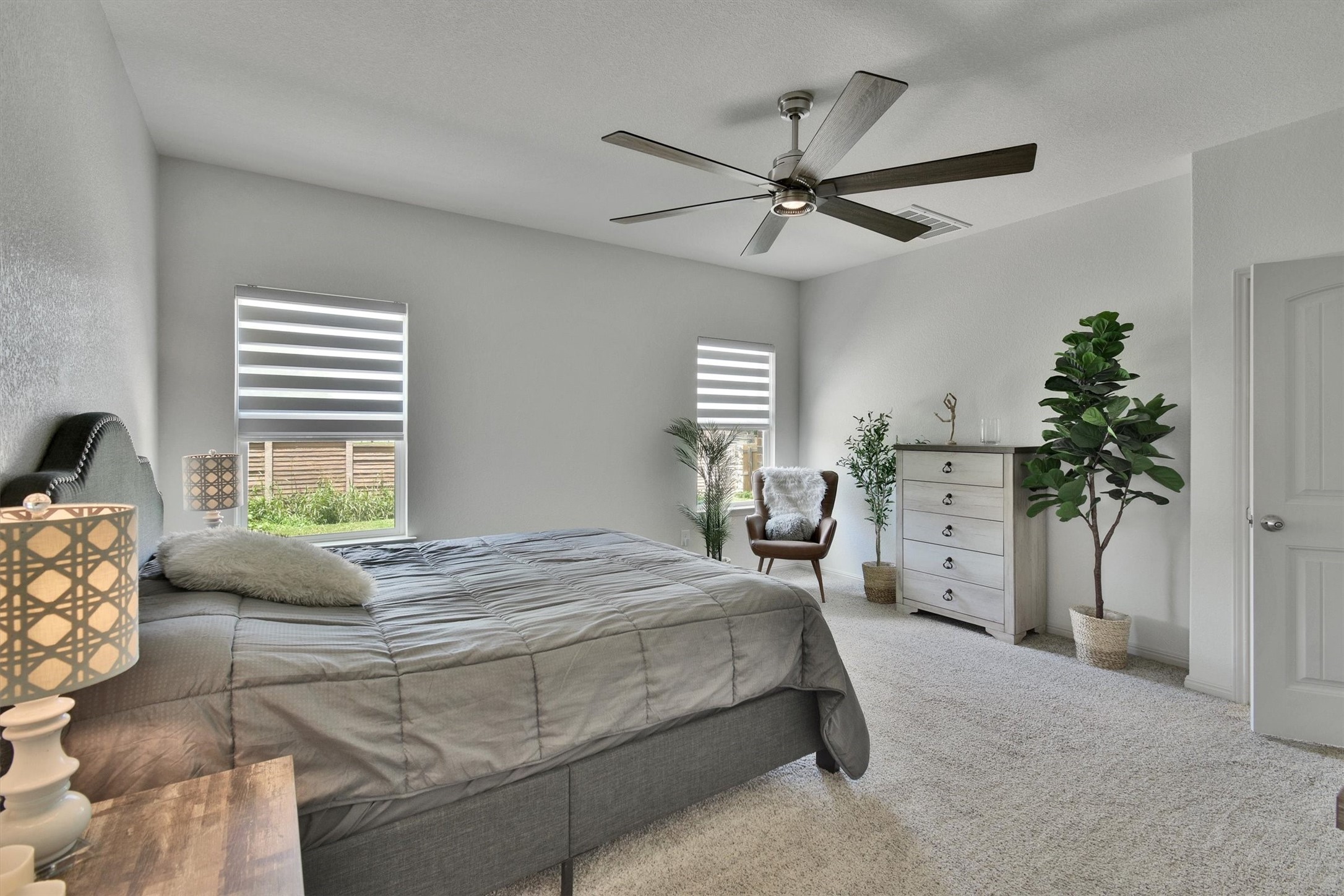 324 Shiner Lane Georgetown, TX 78626 - Photo 19 of 39 a bedroom with a bed and a chandelier