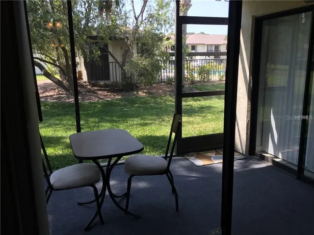 a view of a yard with a table and chairs