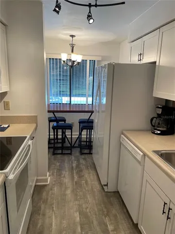 a kitchen with a stove a refrigerator and a table