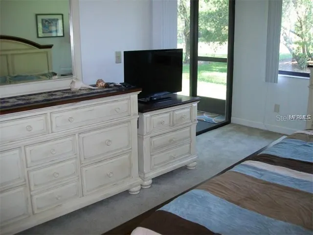 a living room with furniture and flat screen tv
