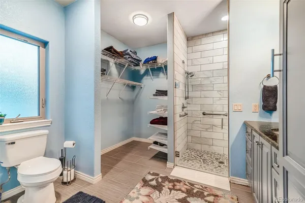 a bathroom with a toilet and a shower