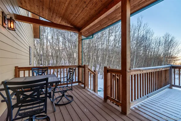 a view of a wooden chairs on the roof deck