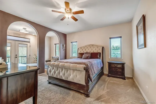 a bedroom with a large bed and a chandelier