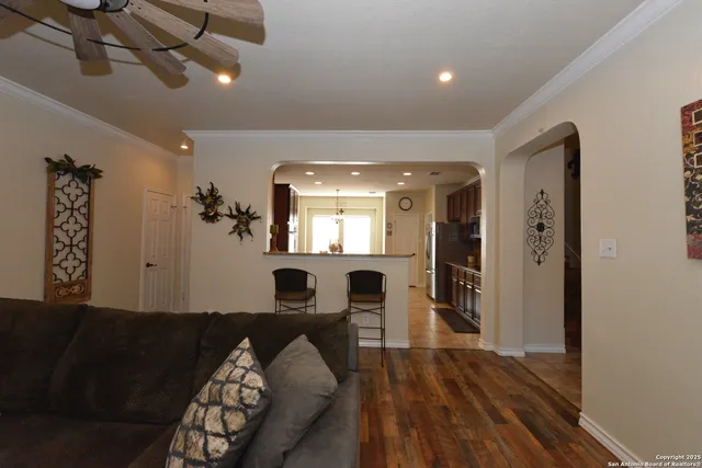 a view of a livingroom with furniture wooden floor and windows