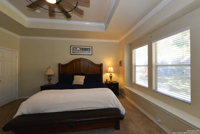 a bedroom with a large bed and a large window