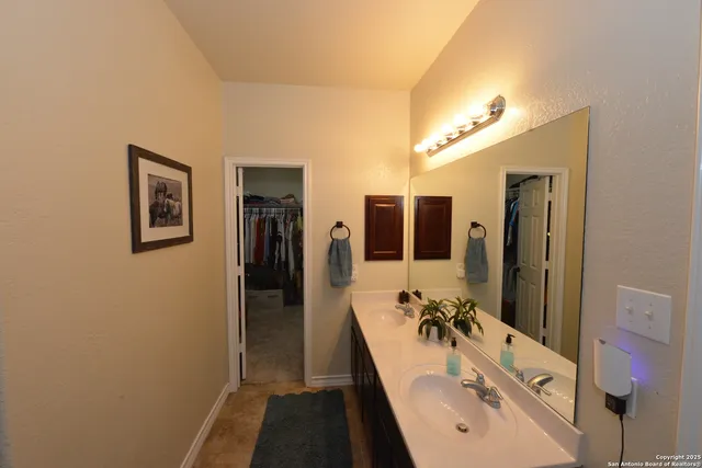a bathroom with a tub sink and mirror