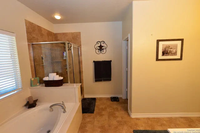 a bathroom with a bathtub and shower