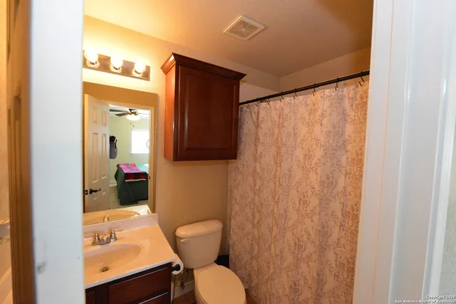 a living room with a bed furniture and a window