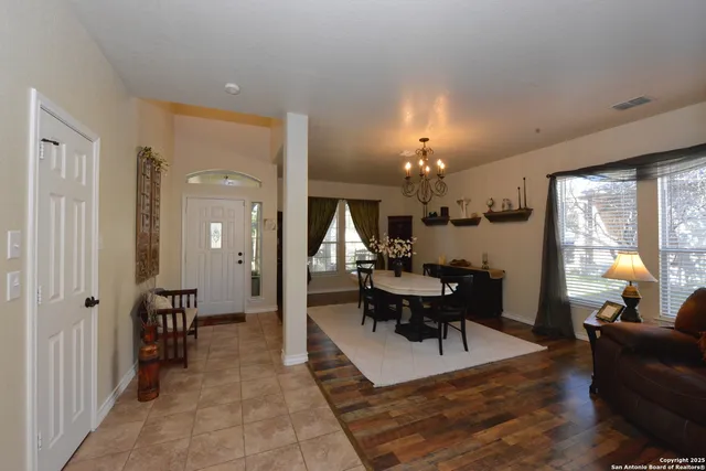 a view of a livingroom with furniture and a chandelier