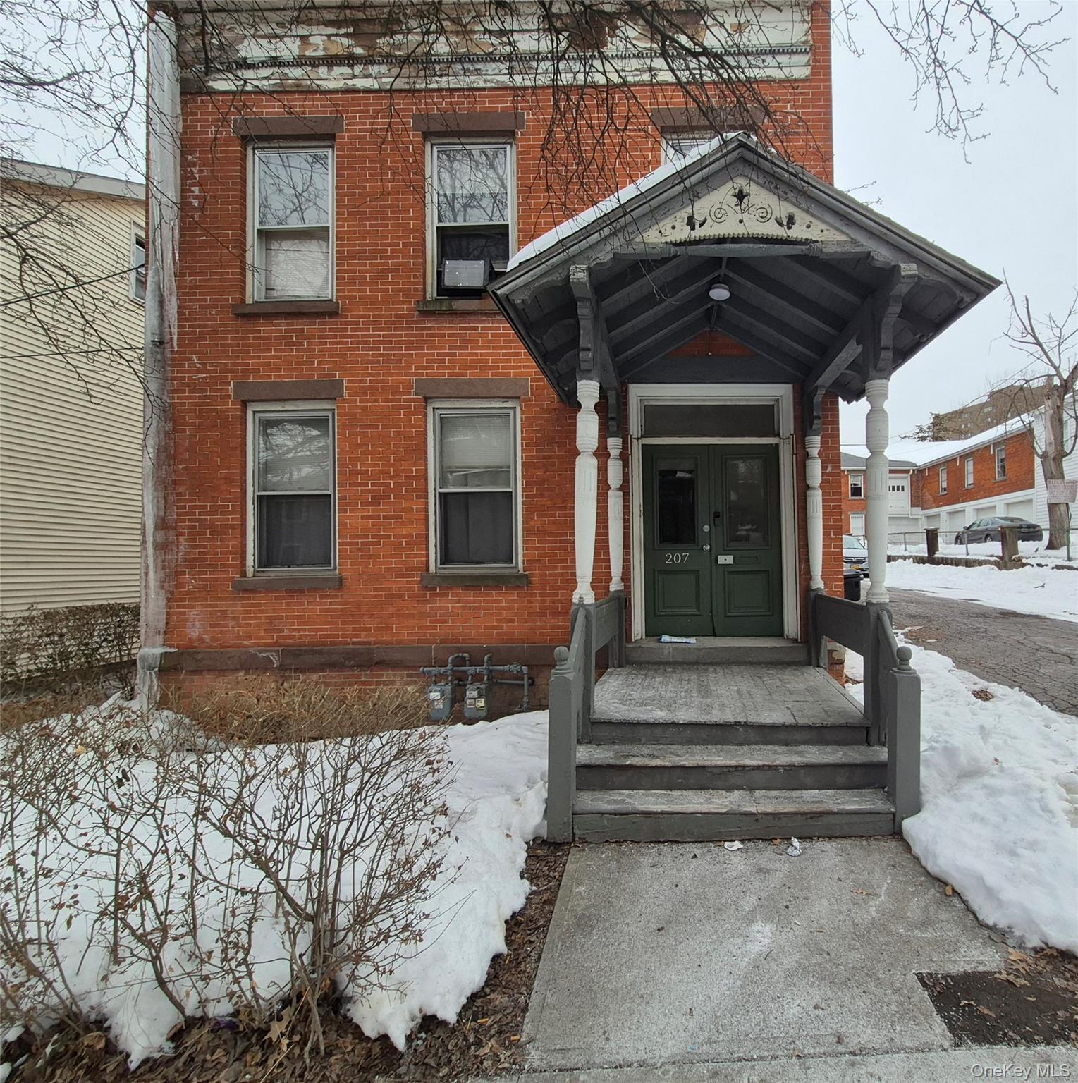 207 Mill Street Poughkeepsie, NY 12601 - Photo 1 of 6 Snow covered property entrance with brick siding and french doors