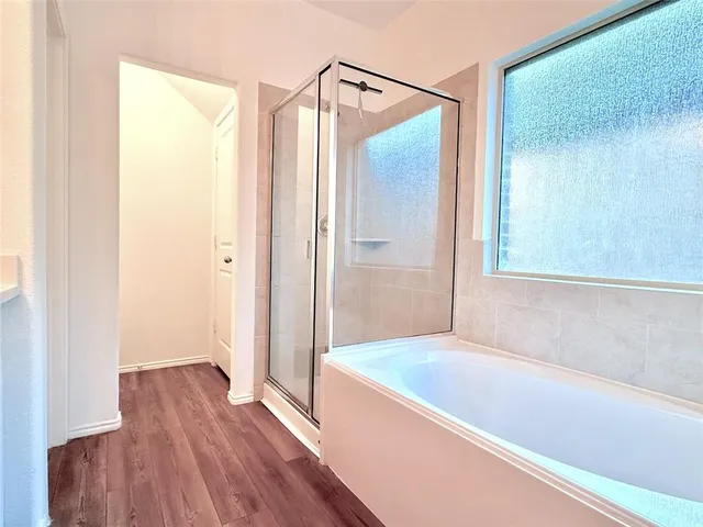 a bathroom with a bathtub and a shower