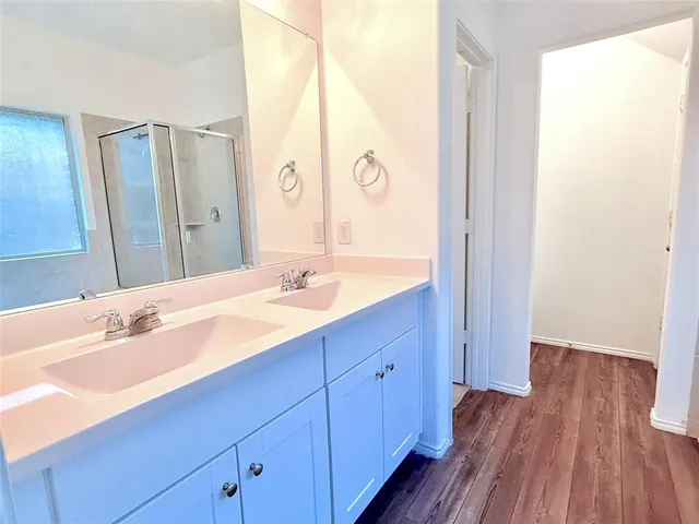 a bathroom with a double vanity sink and mirror