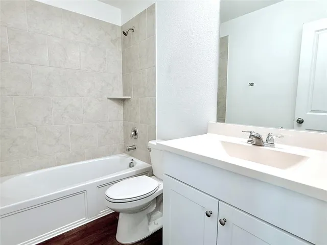 a bathroom with a sink a toilet and a bathtub