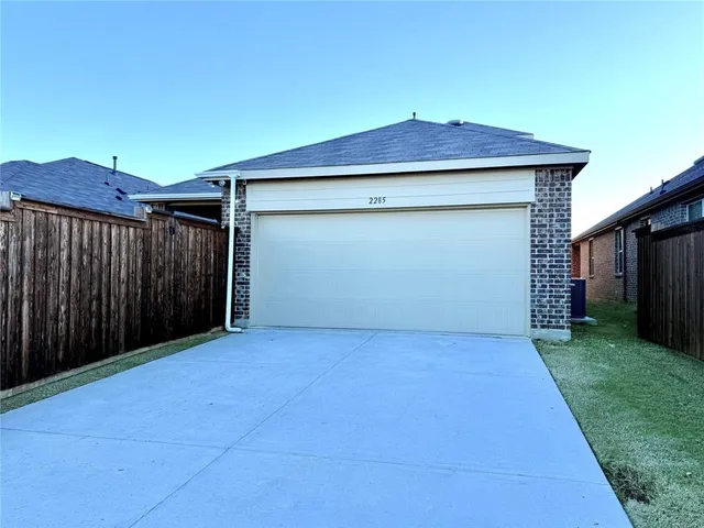 a view of backyard of house with garage