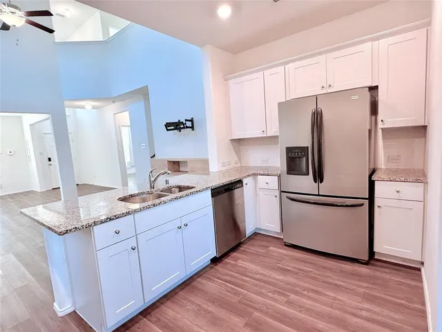 a kitchen with a refrigerator stove and sink