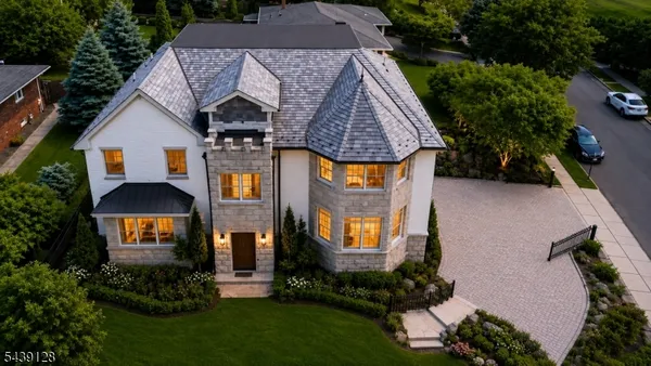 an aerial view of a house with swimming pool and garden
