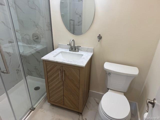 250 West Merrick Road, Unit 2R Freeport, NY 11520 - Photo 21 of 25 Bathroom with marble finish flooring, a stall shower, and vanity