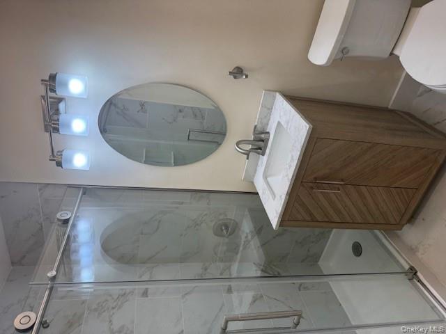 250 West Merrick Road, Unit 2R Freeport, NY 11520 - Photo 23 of 25 Full bath featuring vanity, a stall shower, and marble finish floors