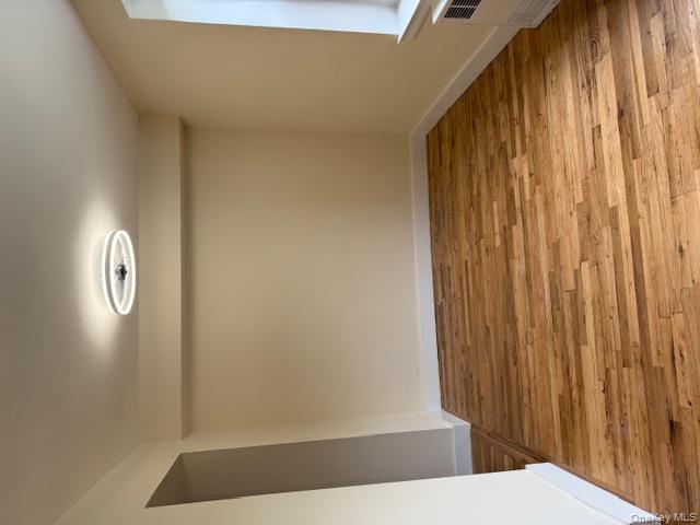 250 West Merrick Road, Unit 2R Freeport, NY 11520 - Photo 4 of 25 Unfurnished room featuring light wood-style flooring and radiator