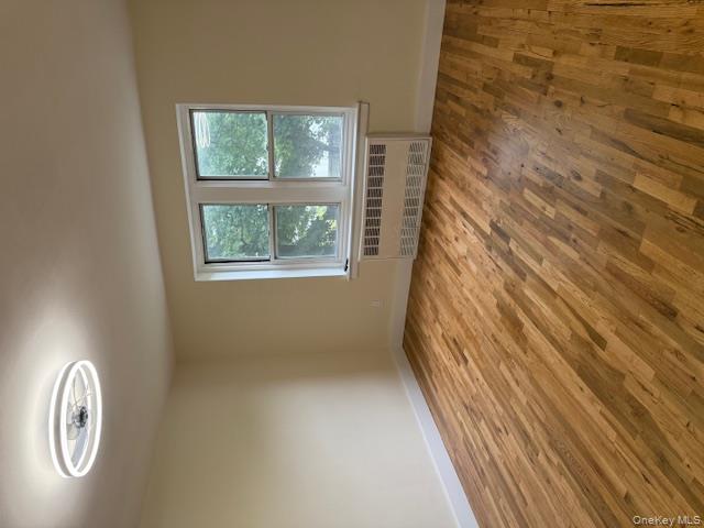 250 West Merrick Road, Unit 2R Freeport, NY 11520 - Photo 9 of 25 Spare room featuring radiator heating unit and wood finished floors
