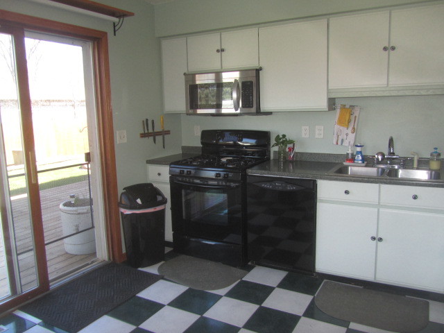 25696 Raska Lane Lake Villa, IL 60046 - Photo 11 of 27 a kitchen with a stove a refrigerator and cabinets