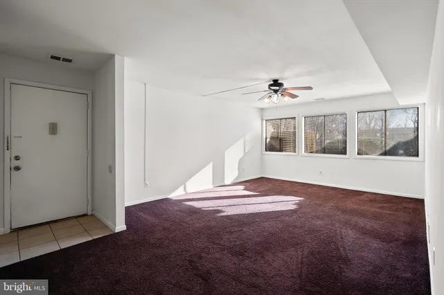 a view of an empty room with a window