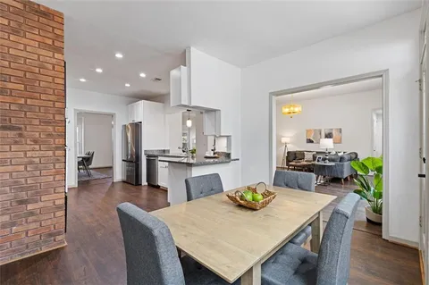 a large kitchen with stainless steel appliances granite countertop a lot of counter space and wooden floor