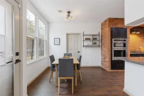 a kitchen with granite countertop a stove a sink and a refrigerator
