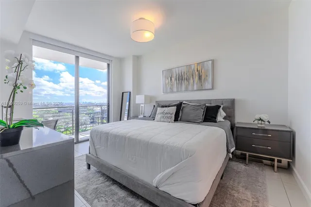 a bedroom with a large bed and a large window