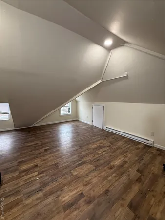 a view of room and hall with wooden floor