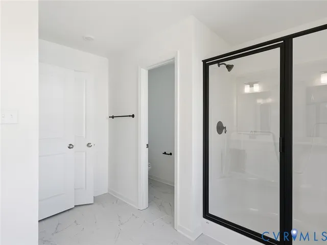 a bathroom with a glass shower door