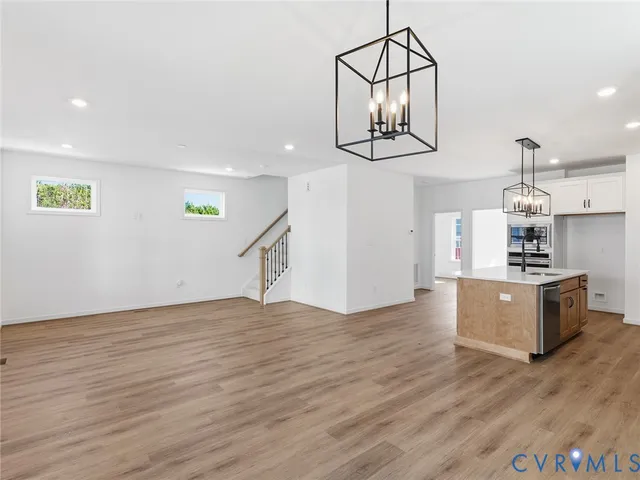a view of a kitchen with wooden floor and a sink