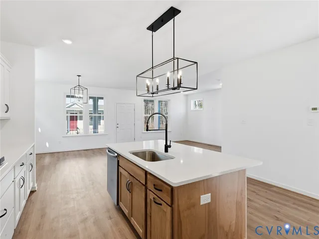 a kitchen with kitchen island a sink a counter space and stainless steel appliances