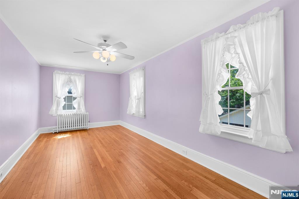 106 Maple Street Rutherford, NJ 07070 - Photo 32 of 50 a view of an empty room with a window and wooden floor