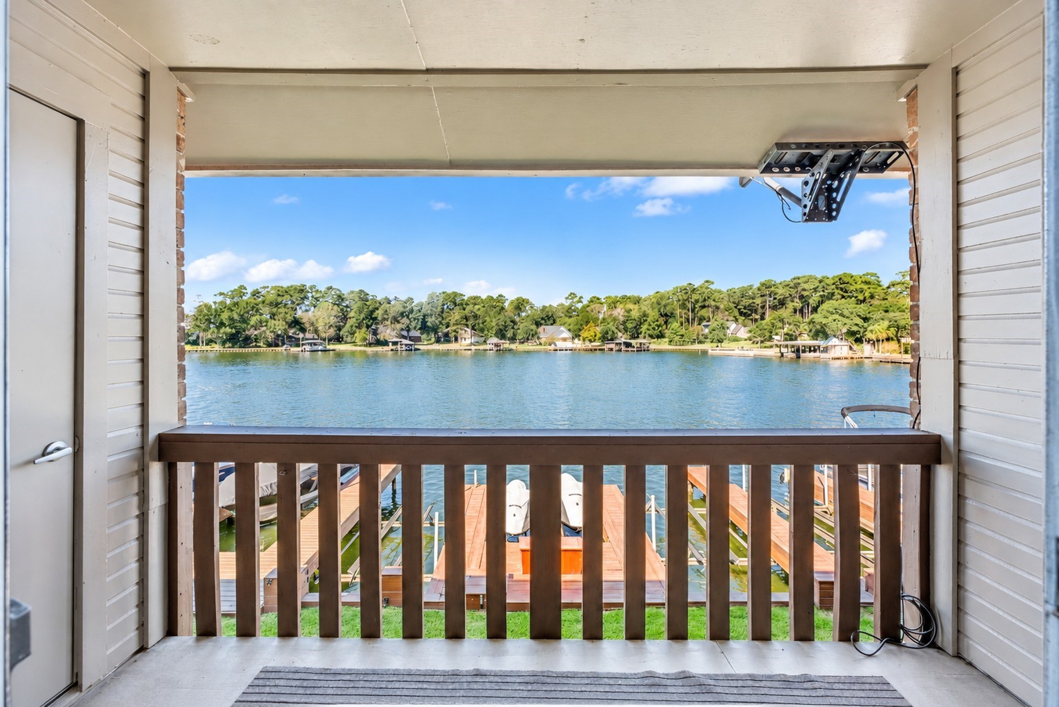 801 River Road, Unit 112F Montgomery, TX 77356 - Photo 18 of 27 Covered balcony offers beautiful open-water views of Lake Conroe, overlooking the community boat slips and the tree-lined shoreline beyond. A wonderful spot to relax, enjoy the breeze, and take in the waterfront setting.